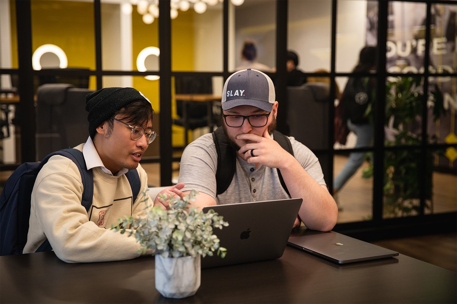 Two male developers working together on ideas for a website.