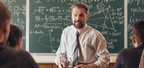 Cheerful bearded professor having a casual informal conversation with students during math seminar