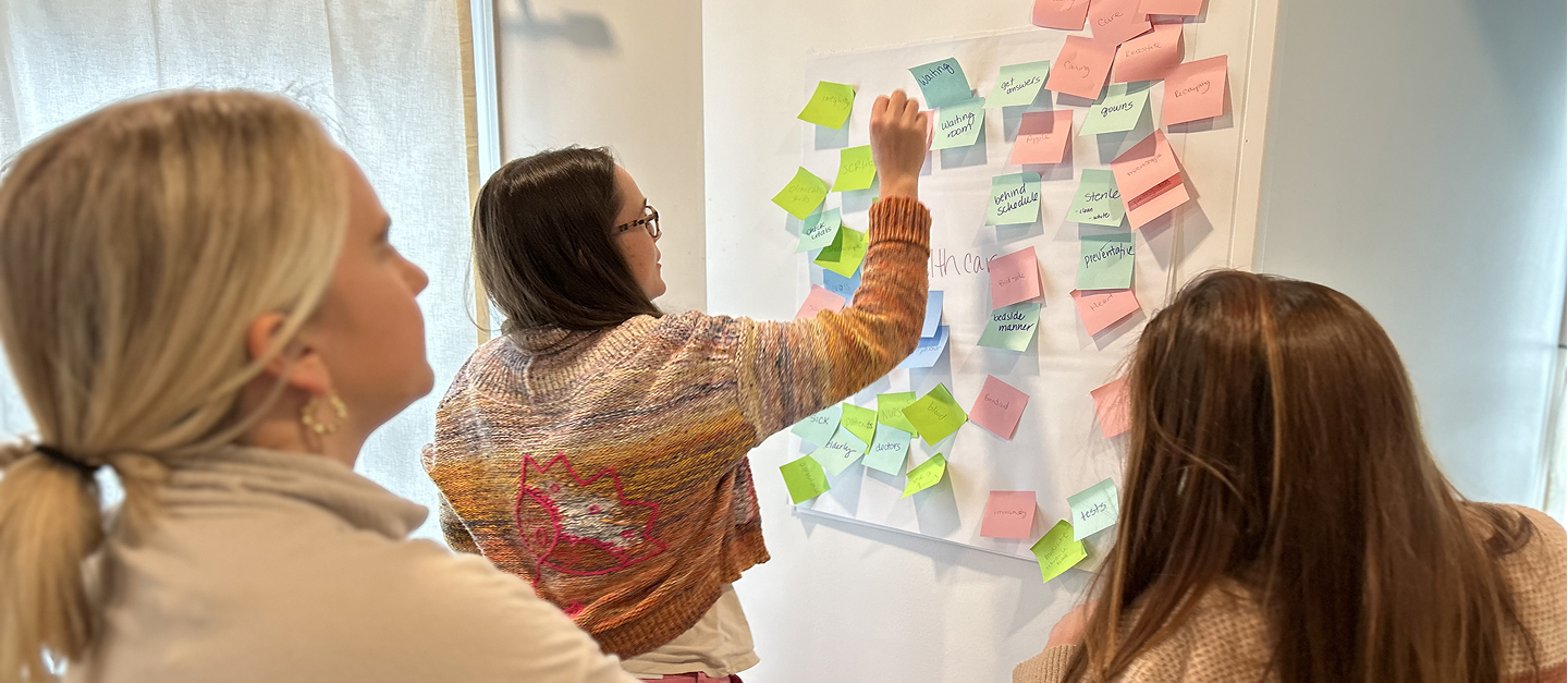 Three female creatives working together on ideas for a website.
